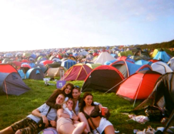 Un groupe d'amis devant leurs tentes sur le camping du festival